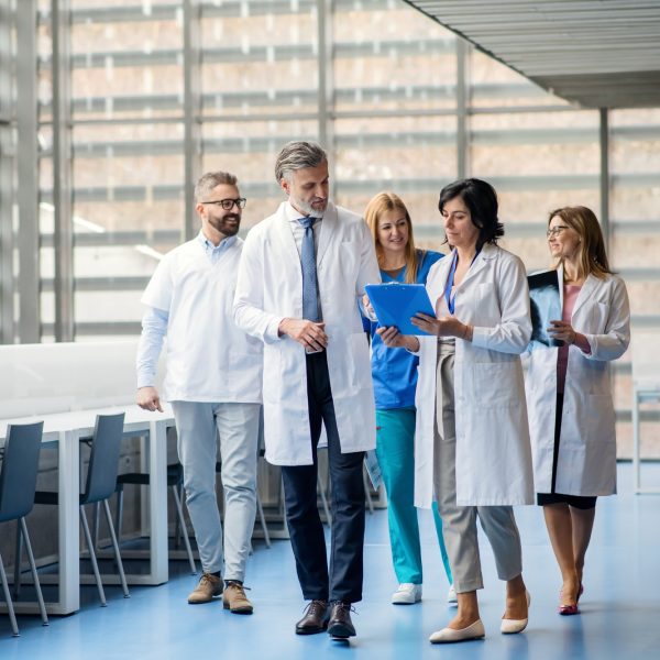 Group of doctors walking in corridor on medical conference
